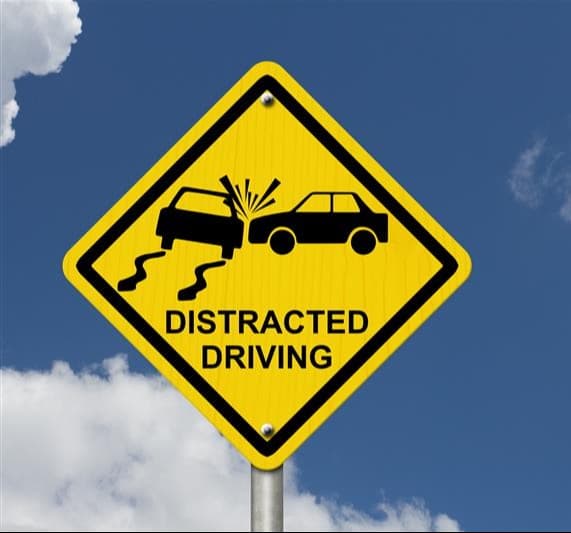 Traffic warning sign illustrating a collision between two cars to highlight distracted driving risks Traffic warning sign illustrating a collision between two cars to highlight distracted driving risks