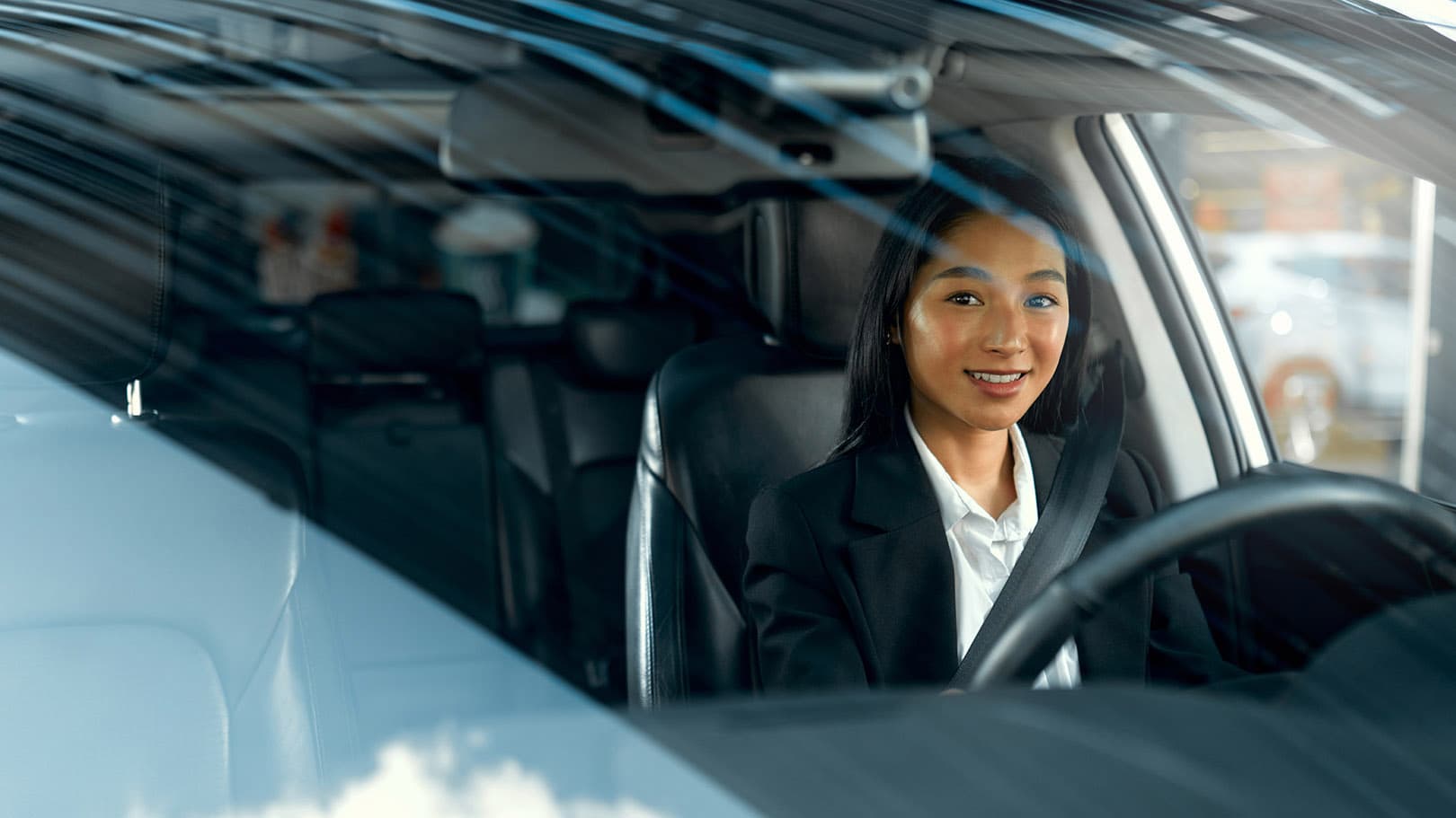 A professional woman driving a car. A professional woman driving a car.