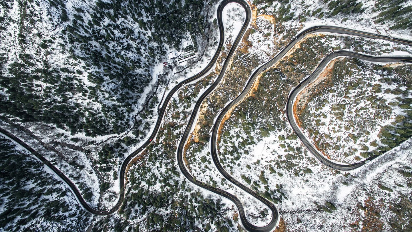 winding-mountain-road-winter-aerial winding-mountain-road-winter-aerial