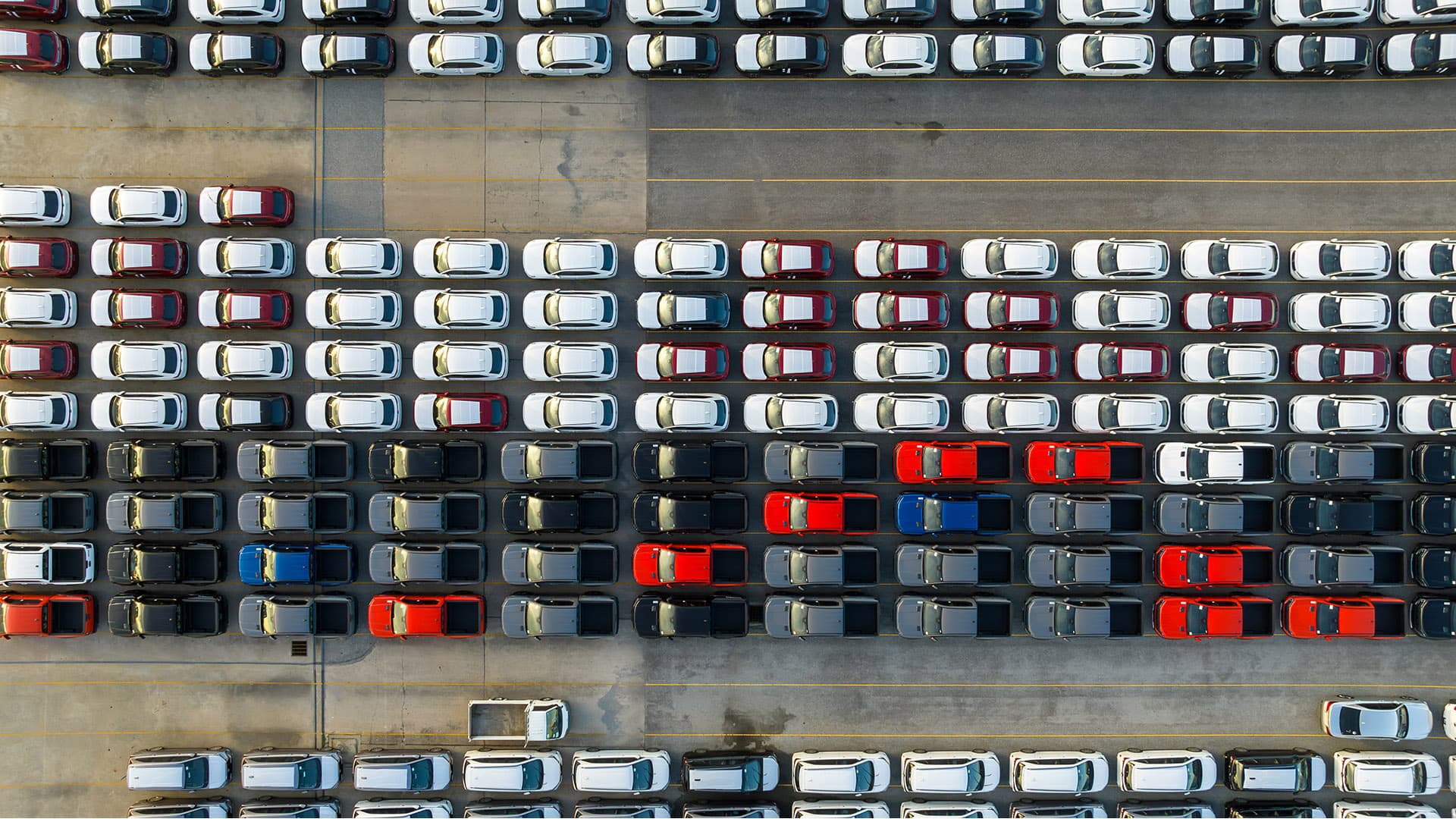 Aerial view of new electric vehicles parked at an EV charging station. Aerial view of new electric vehicles parked at an EV charging station.